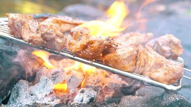 Grilled meat over charcoal