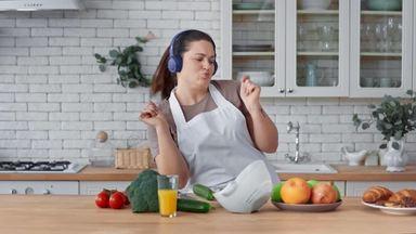 chubby woman dancing in front of ingredients