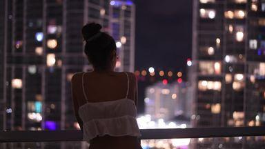 young woman looking at the night view