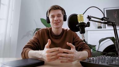 male podcaster looking at the camera