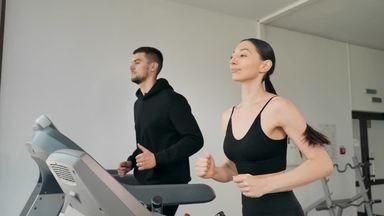 Men and women running on running machines