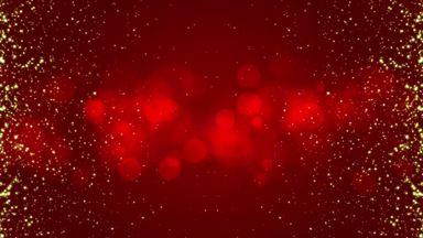 The effect of floating golden grains on a red background