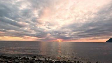 八丈島の横間海岸から見える波打ち際と夕日
