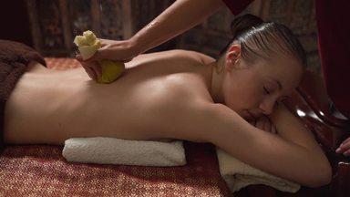 woman doing herbal ball massage