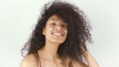 Woman with curly hair shaking her head