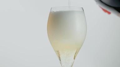 Pour champagne into a glass