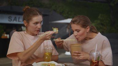 a woman who eats while listening to her friends