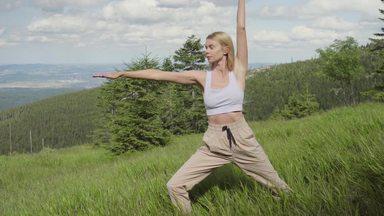woman doing yoga in the meadow