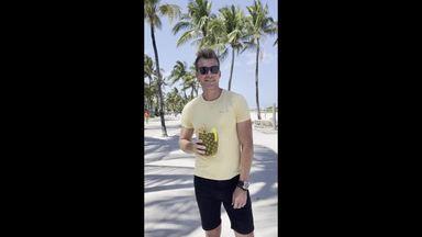 men with tropical drinks on the beach