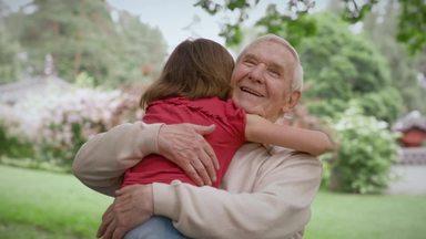 grandpa hugging the girl who ran up