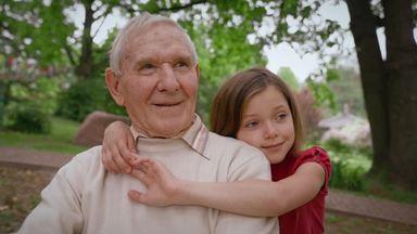 girl looking into the distance with grandpa