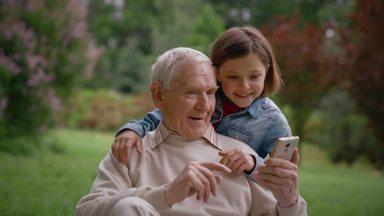 grandpa looking at a girl and a smartphone