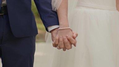 bride and groom holding hands firmly